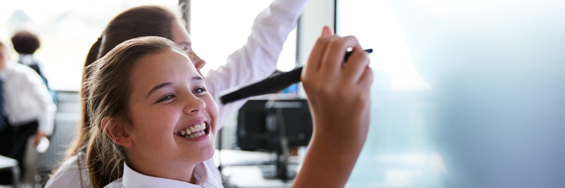 Students writing on the board in class
