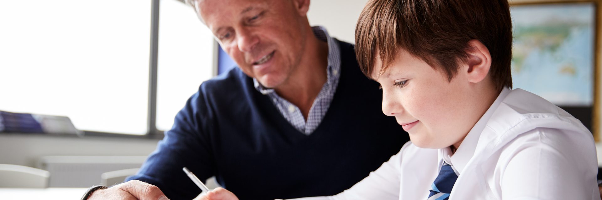 Male Teacher working with student