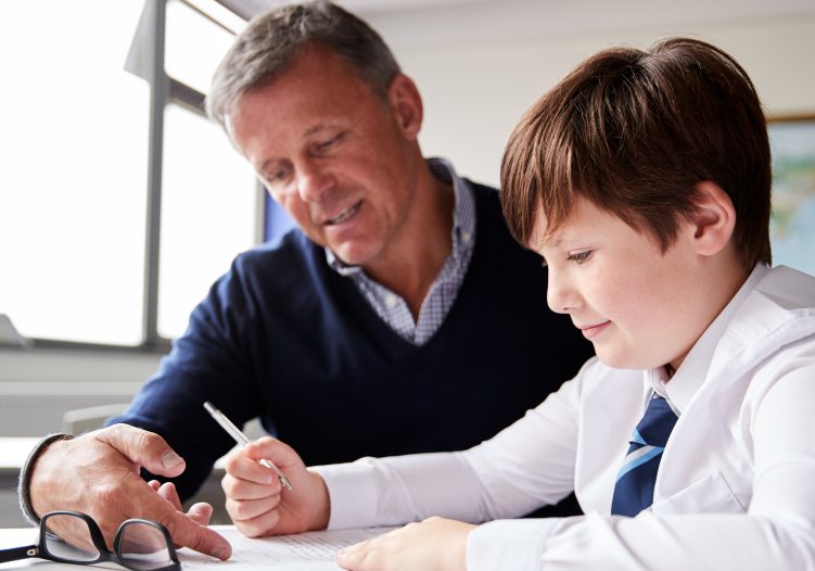 Male Teacher working with student